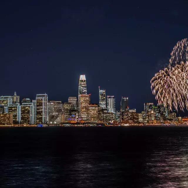 Fireworks explode over the San Francisco city skyline.